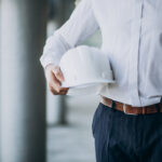 Handsome business man engineer in hard hat in a building